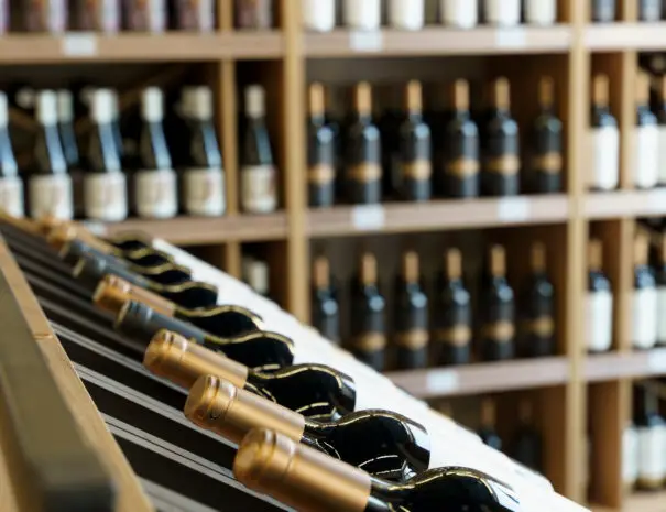 Wine bottles with blank labels on the counter of a liquor store. Wine background. High quality photo